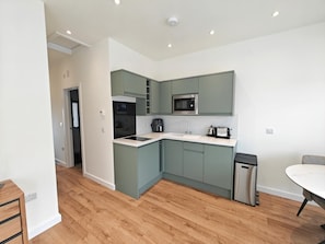 A modern kitchen with a microwave, coffee maker, and stainless steel dishwasher. - 1 Bed in Tisbury (oc-b36626) (Tisbury)