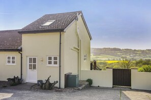 A two-story building with a flat roof, a small window, and a door. - 2 Bed in Upottery (oc-s36296) (Upottery)