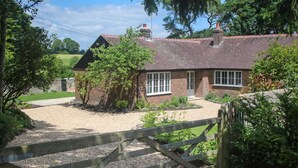 A brick house with a gravel driveway and a wooden gate. - 3 Bed in Berwick St. John (oc-k36615) (Berwick Saint John)
