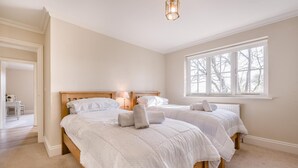 A bedroom with two beds, a window, and a lamp. - 3 Bed in Berwick St. John (oc-k36615) (Berwick Saint John)