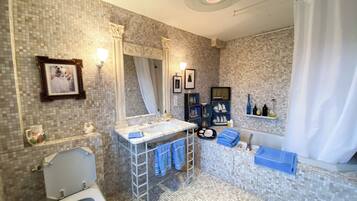 Een badkamer met toilet, wastafel, bad en douchegordijn.