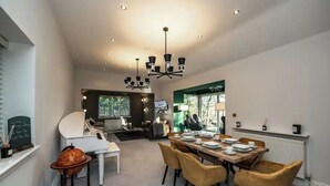 A modern dining area with a large table, yellow chairs, and a chandelier. - 2 Bed in Crook O Lune (oc-h36291) (Halton)