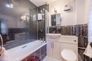 A modern bathroom with a bathtub, a shower, a sink, and a toilet. - 2 Bed in Thwaite (oc-s36623) (Thwaite)