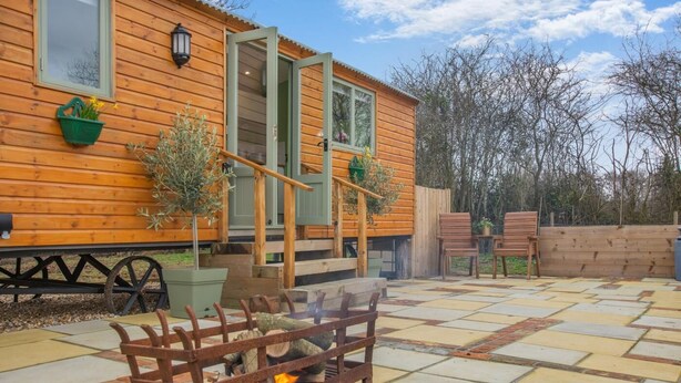 A wooden cabin with a fire pit, outdoor seating, and a wooden deck. - 1 Bed in Marden (oc-c34994) (Horsmonden)