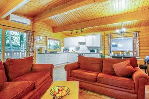 A wooden cabin interior with a living room, kitchen, and dining area. - 3 Bed in Kenwick (oc-l36924) (Legbourne)
