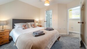 A bedroom with a bed, bedside tables, a wardrobe, and a door leading to another room. - 3 Bed in Wanlockhead (oc-g36354) (Wanlockhead)