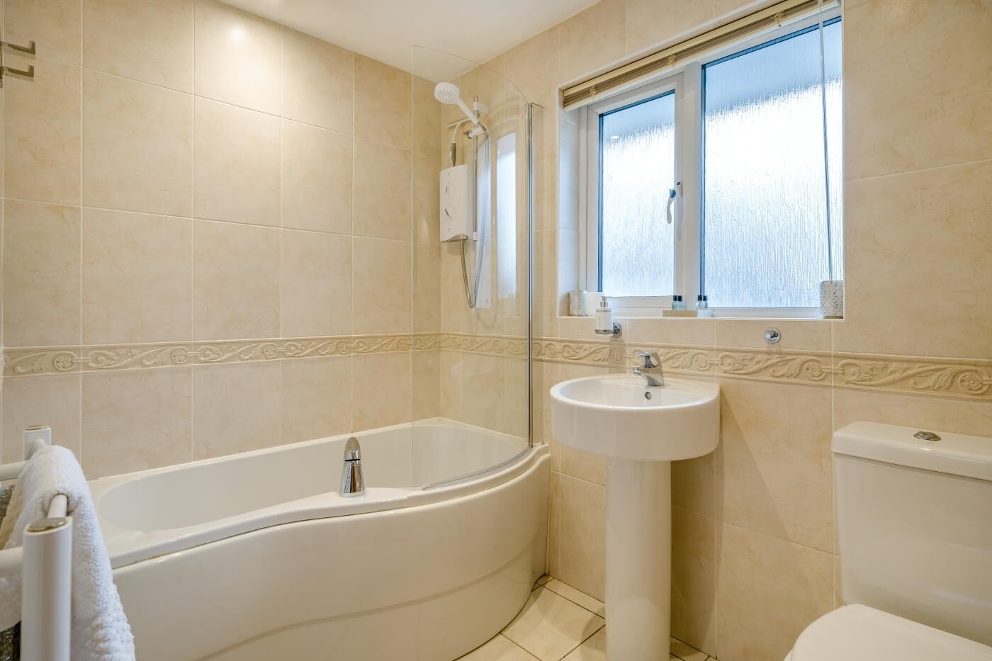 A bathroom with a bathtub, a sink, and a toilet.