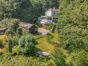 A residential property with a large house, a smaller shed, and a well-maintained garden with a dining area. - 5 Bed in St. Agnes (oc-q37500) (Saint Agnes)