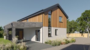 A modern two-story house with a stone facade, wooden upper levels, and a paved driveway. - 4 Bed in Padstow (oc-p36069) (Constantine Bay)