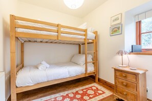 A bunk bed room with a wooden ladder, a bedside table with a lamp, and a window with a view. - 3 Bed in Longnor (oc-r34925) (Longnor)