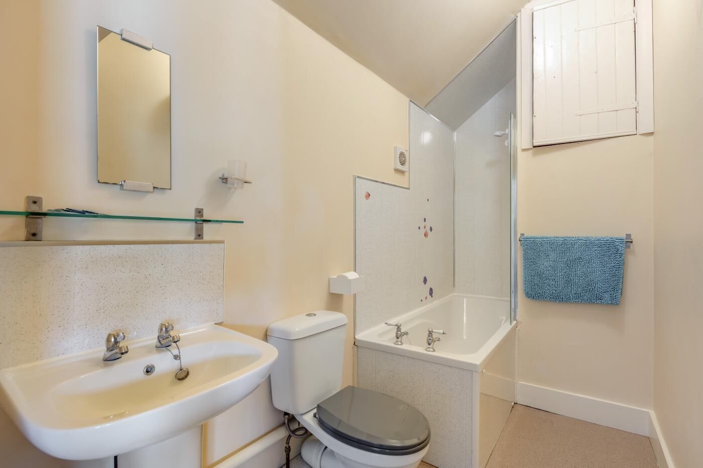 A bathroom with a sink, toilet, and bathtub.