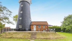 A lighthouse with a brick building adjacent to it, a staircase leading up to the building, and a clear sky. - 2 Bed in Wrangle (oc-t37494) (Old Leake)
