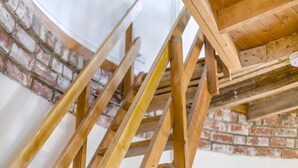 A wooden staircase with a brick wall background. - 2 Bed in Wrangle (oc-t37494) (Old Leake)