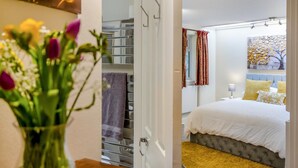 A bedroom with a bed, a bedside table, a lamp, and a window with curtains. - 1 Bed in Hexham (oc-g37537) (Hexham)