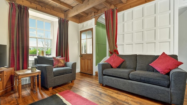 A living room with two sofas, a wooden coffee table, and a TV. - 2 Bed in Gunnerside (oc-g37866) (Gunnerside)