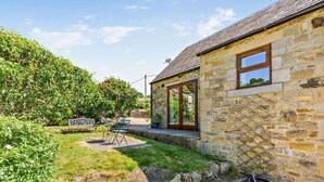 A stone house with a garden, a bench, and a table with chairs. - 2 Bed in Hexham (oc-92527) (Catton)