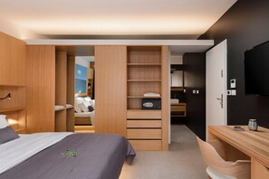 A modern bedroom with a bed, wooden wardrobe, and a desk area. - Villa Etesia - Three Bedroom Villa, Sleeps 6 (Marušići)