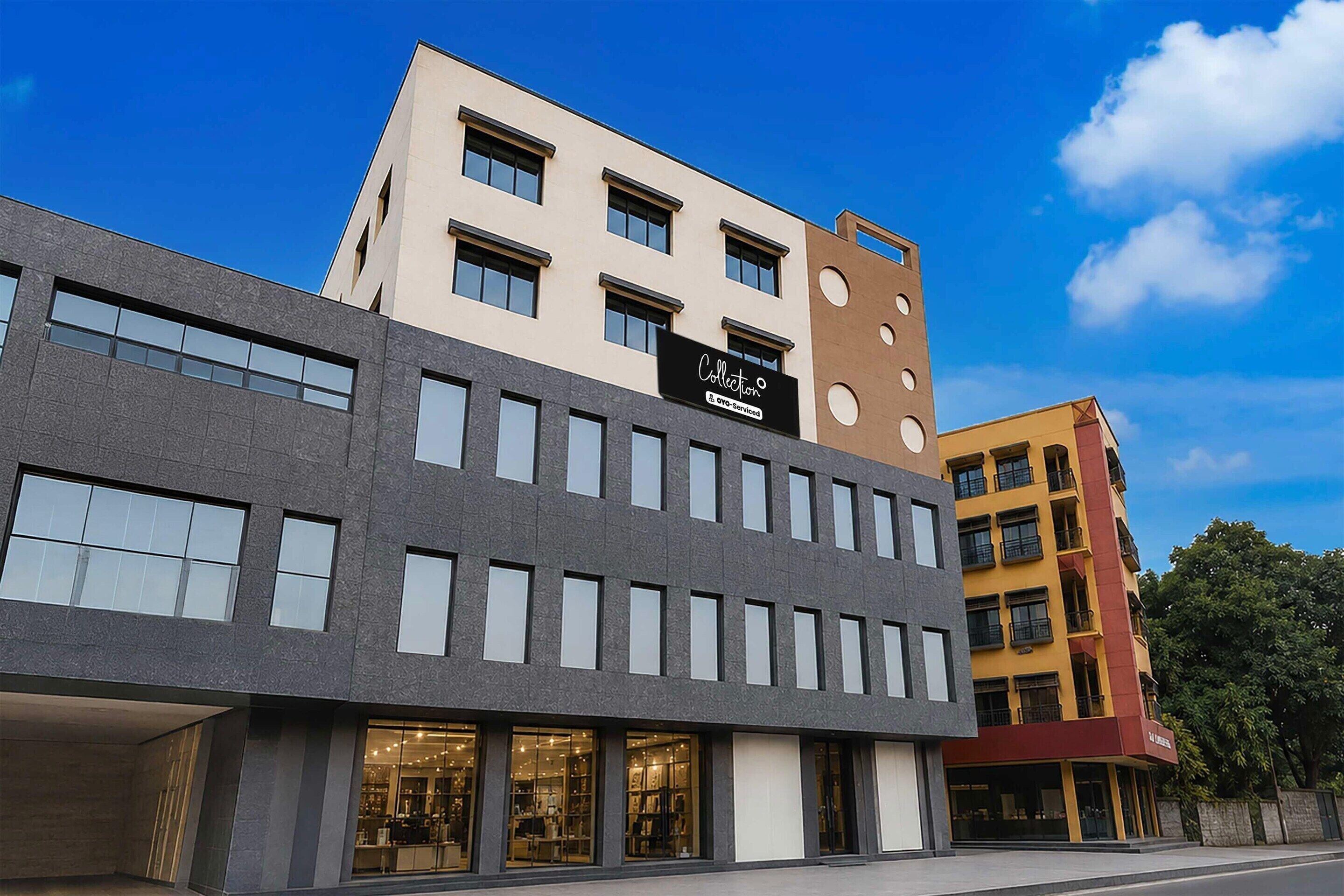 A multi-story building with a mix of window styles and a storefront with a sign.