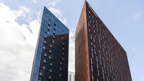 Two modern high-rise buildings with reflective glass facades and a clear sky. - Students Only - Unite Parkway - Manchester (Manchester)