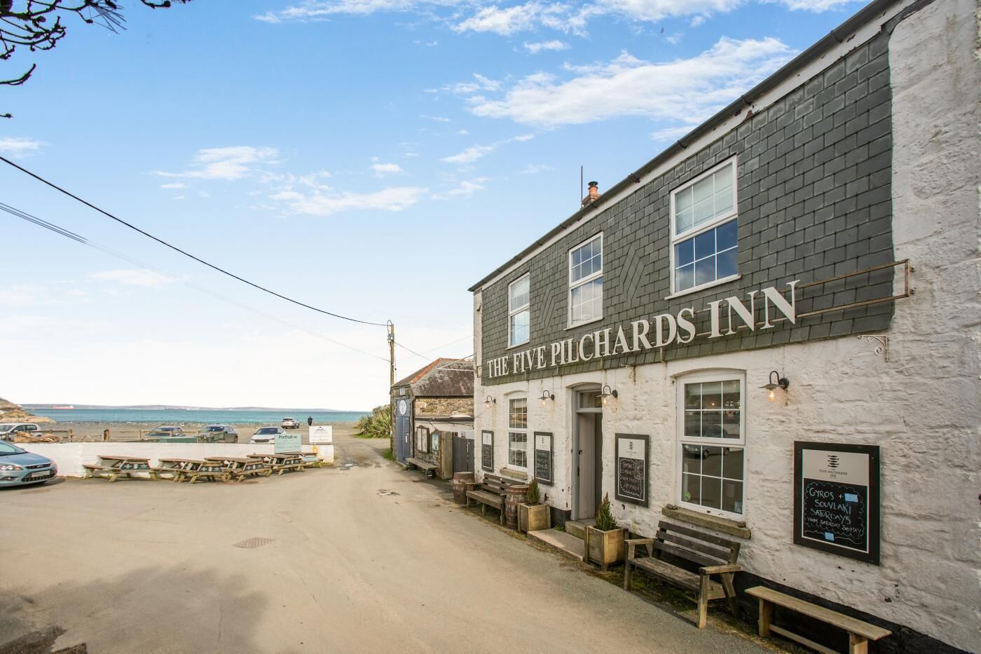 The Five Pilchards Inn with a view of the sea.