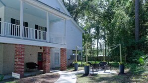 A building with a porch, outdoor seating, and a sign indicating a retreat.