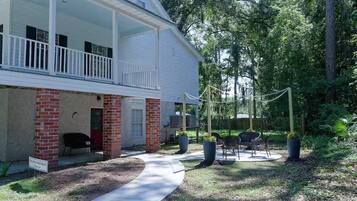 A building with a porch, outdoor seating, and a sign indicating a retreat.