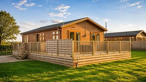 A wooden cabin with a porch, a staircase, and a fenced deck. - 1 Bed in Athelington (oc-r35078) (Athelington)