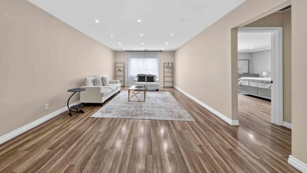 A spacious living room with a large window, a sofa set, a coffee table, and a small side table. - Peaceful Tujunga Retreat Mountain Views Near Universal (Los Angeles)