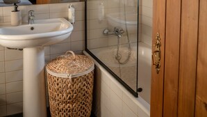 A bathroom with a glass-enclosed shower, a sink, and a wooden door. - Casa Rosa Chalet with Shared Pool, Wi-Fi and Air Conditioning (São João da Pesqueira)
