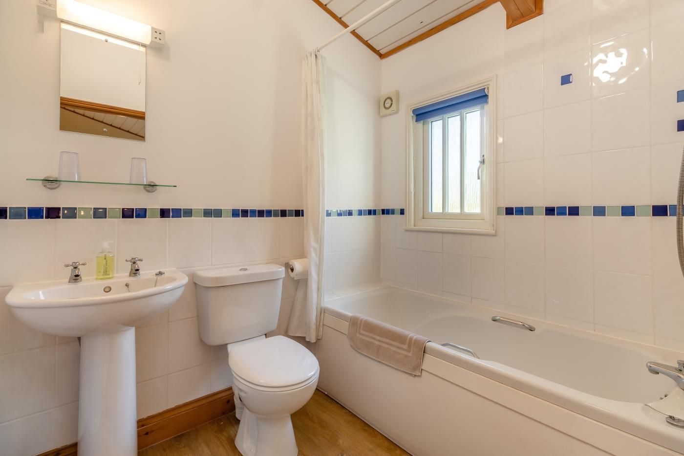 Un baño con inodoro, lavamanos y bañera.