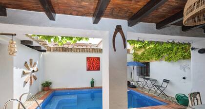Luxury bedroom in Los Bermejales with a view of the pool.
