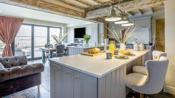 A spacious kitchen with a large island, modern appliances, and a view to the outside. - 4 Bed in Liddington (oc-p38233) (Liddington)