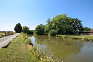 A calm river with a wooden fence and a building on the right. - 2 Bed in Pocklington (oc-s39067) (Pocklington)