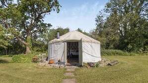 A yurt with a covered entrance, a fire pit, and a small outdoor seating area. - 1 Bed in Bronington (oc-d39075) (Bronington)