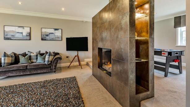 A living room with a fireplace, a sofa, a flat-screen TV, and a foosball table. - 5 Bed in Weeton (oc-p39054) (Weeton-with-Preese)