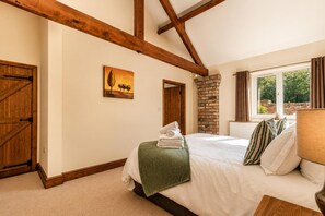 A bedroom with a bed, a window, a brick wall, and wooden beams. - 1 Bed in Gransmoor (oc-s37885) (Gransmoor)