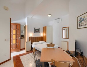 A hotel room with a bed, bedside table, chair, desk, and a TV. - Pet-friendly Apartment With Terrace (Medulin)