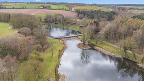 A river with a bridge, surrounded by fields and trees. - 1 Bed in Edgefield (oc-h39008) (Edgefield)