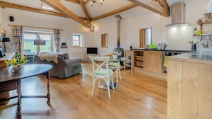 A spacious living area with a wooden ceiling, a dining table, a sofa, and a kitchen with wooden cabinets. - 1 Bed in Shap (oc-t41418) (Shap)