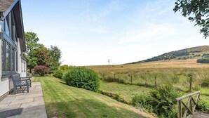 A property with a patio, outdoor seating, and a view of a grassy field. - 3 Bed in Penrith (oc-89427) (Hutton)