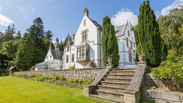 A large, white, multi-story building with a stone staircase leading up to the entrance. - 12 Bed in Tomatin (oc-ca203) (Woodend)