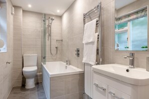 A modern bathroom with a glass-enclosed shower, a standalone toilet, a freestanding bathtub, and a vanity with a mirror. - 2 Bed in Windermere (oc-lr001) (Windermere)