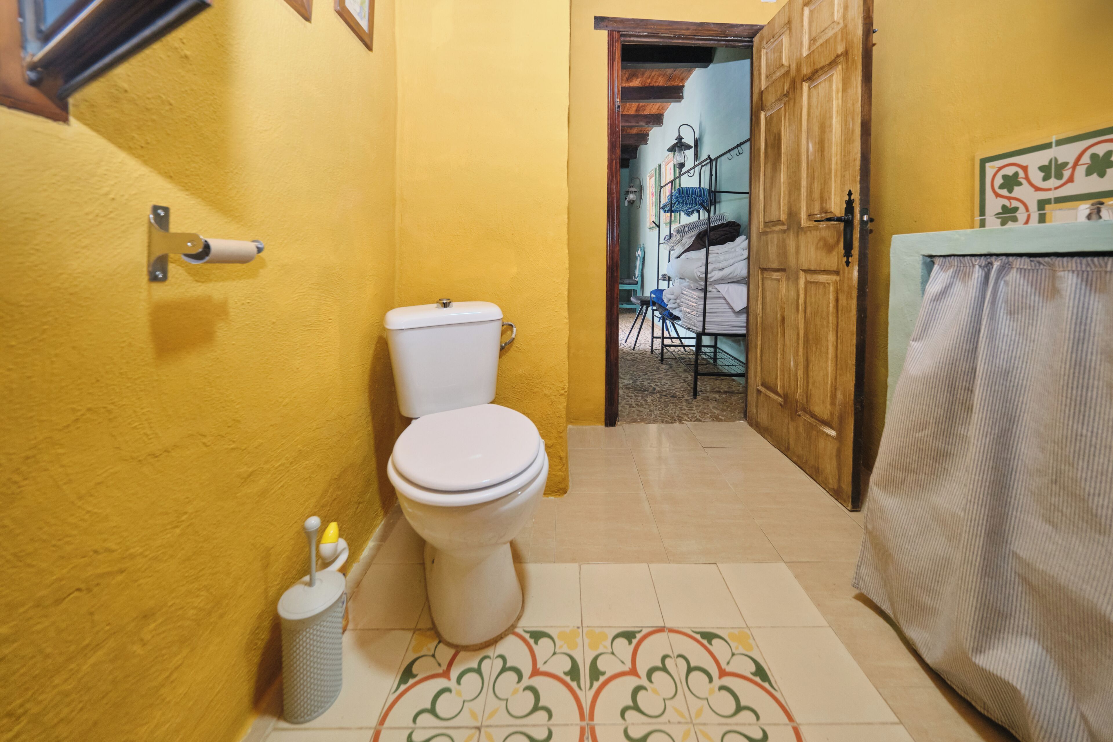 Une salle de bain comprenant des toilettes, un lavabo et un espace douche.
