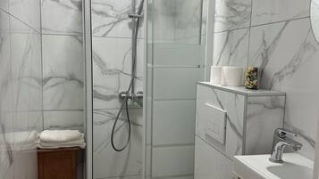 Shower, hair dryer, towels, toilet paper