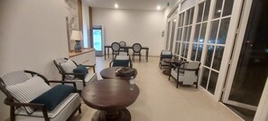 A hotel lobby with seating arrangements, a reception desk, and a large window providing a view. - Star Bay Boutique Hotel Phu Quoc  (Phu Quoc)