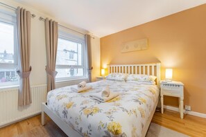 A bedroom with a bed, a nightstand, a window with curtains, and a radiator. - 2 Bed in Keswick (oc-lr147) (Keswick)
