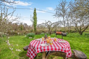 An outdoor picnic setup with a checkered tablecloth, a metal chair, and a rustic table. - 2 Bed in Westfield (oc-b40267) (Sedlescombe)