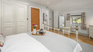 A bedroom with a bed, a wooden door, a mirror, a chair, and a window with curtains. - 2 Bed in Easington (oc-coq114) (Easington)