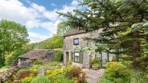 A stone house with a garden, a small structure with a satellite dish, and a stone wall. - 2 Bed in Buxton (oc-dcbap) (Crowdecote)