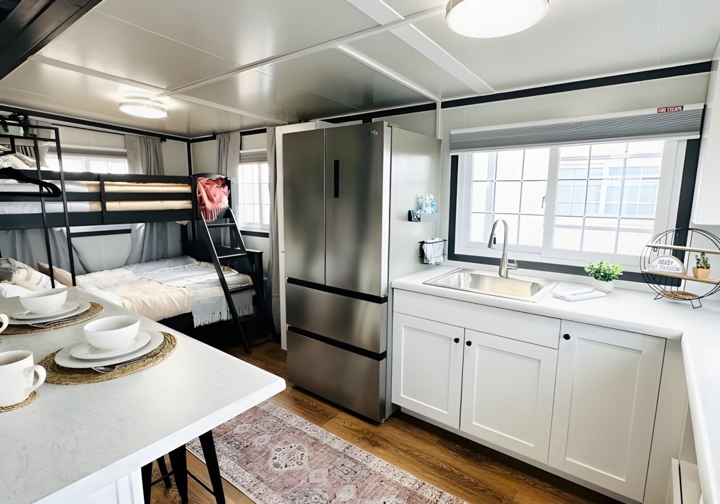 A compact kitchen with a refrigerator, sink, and a window.